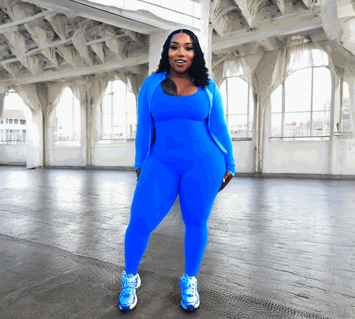 POWER SLEEVELESS JUMPSUIT in bright blue, featuring moisture-wicking fabric, detachable padding, and a V-shaped scrunch back design, ideal for workouts.