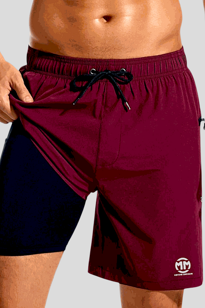 Men's Performance 7 Shorts with 2-in-1 design, compression lining, quick-dry fabric, zipper pockets, and elastic waistband in maroon and black.