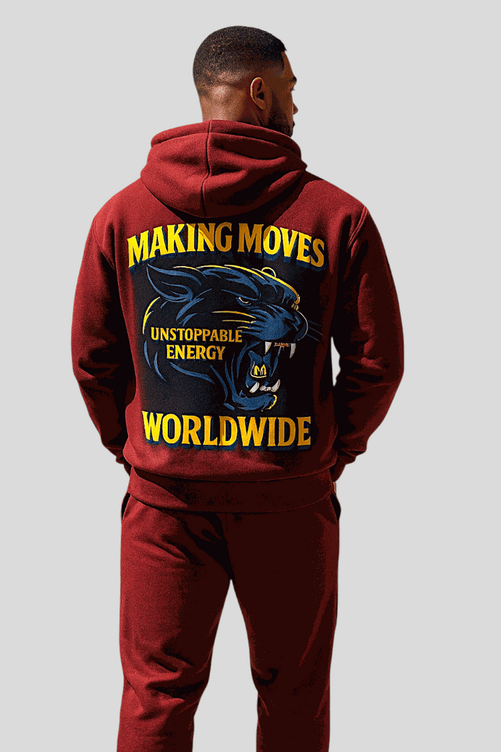 Man wearing burgundy Unstoppable Hoodie with bold panther graphic and "Making Moves Worldwide" text on back