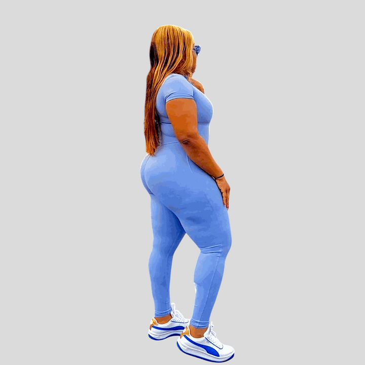Main Character 2.0 jumpsuit in blue, tight fit, short sleeves, above-the-ankle length, with a mock neck zipper.